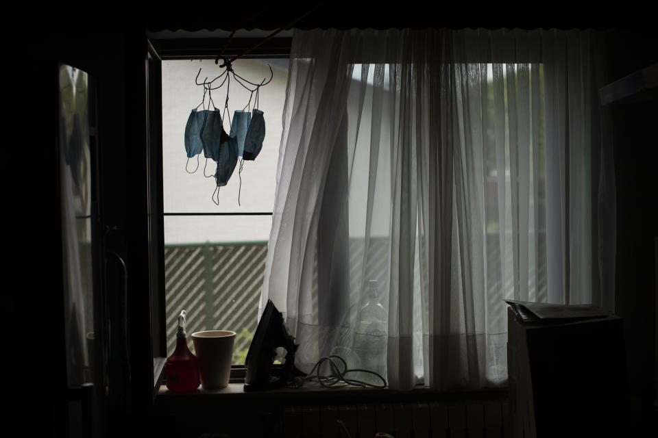 In this photo taken on Wednesday, April 29, 2020, masks hang on a wire next to a window at Frederico Taramaschi's home in Alken, Belgium. Taramaschi's mother, Diane Wanten, 61, is currently on home quarantine at the house of her son after being treated for two weeks at the Jessa Hospital intensive care ward for COVID-19 coronavirus patients. (AP Photo/Francisco Seco)