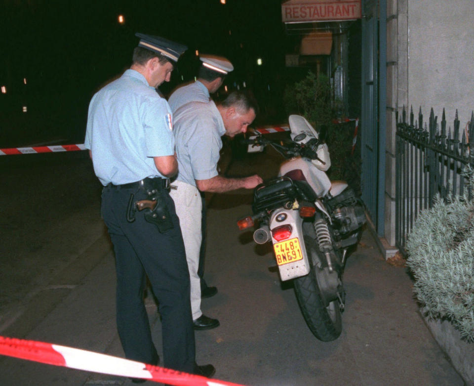 FILE - Police prepare to remove for investigation the motorbike of a photographer that was chasing the car of Diana, Princess of Wales, when a crash took place in a tunnel along the Seine river in Paris, Aug. 31, 1997. The story of Princess Diana's death at age 36 in that catastrophic crash in a Paris traffic tunnel continues to shock, even a quarter-century later. (AP Photo/Jacques Brinon, File)