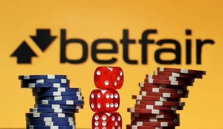Betfair logo is seen behind gambling dice and chips in this illustration taken in Sarajevo, September 10, 2015. REUTERS/Dado Ruvic