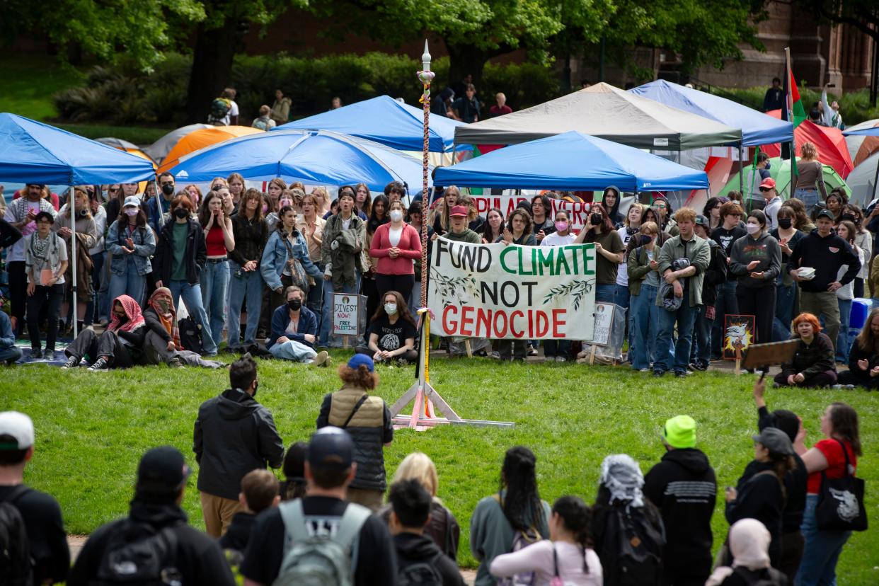People gather around a maypole during a May Day rally in support of Palestinians Wednesday, May 1, 2024, on the campus of the University of Oregon in Eugene, Ore.