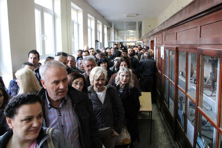 People wait in line to cast their votes at a polling station during Serbian presidential election in the ethnically divided town of Mitrovica, Kosovo April 2, 2017. REUTERS/Agron Beqiri