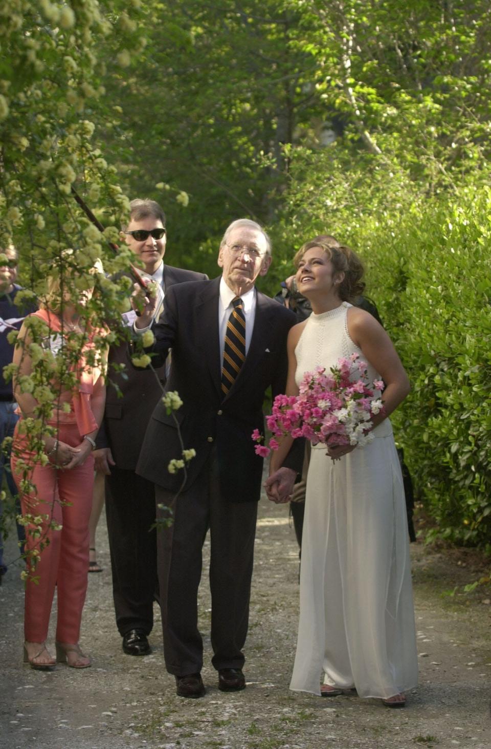 Henry Rehder escorts Nikki DeLoach, Queen Azalea 2001, through his garden. Rehder's garden was the site of the official portrait of the Azalea queen for more than 50 years.