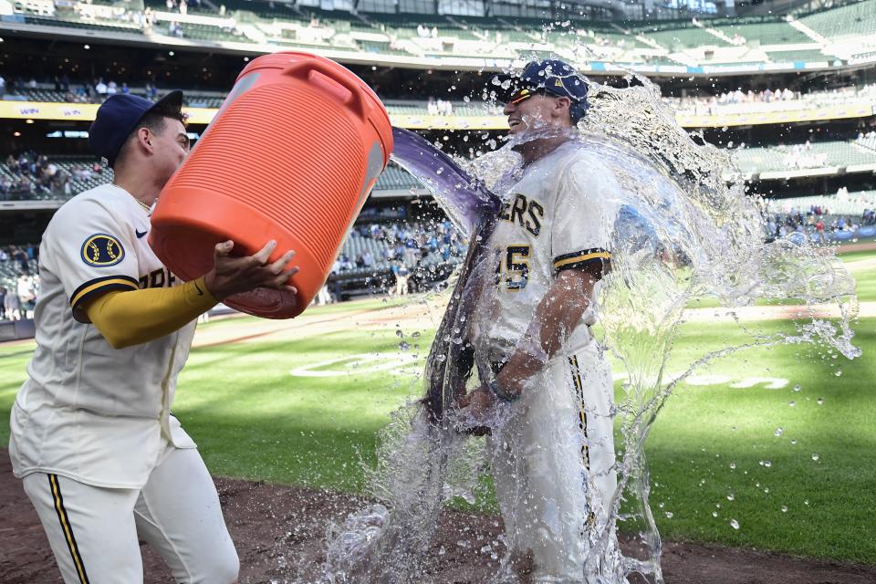 Sep 14, 2023; Milwaukee, Wisconsin, USA; Milwaukee Brewers left fielder Tyrone Taylor (15) is dunked by shortstop Willy Adames (27) after the Brewers beat the Miami Marlins at American Family Field. Mandatory Credit: Benny Sieu-USA TODAY Sports