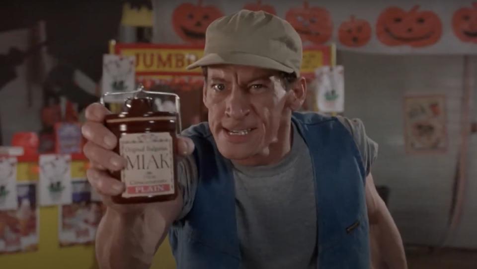 Ernest holds a jar of Miak in a gymnasium in Ernest Scared Stupid