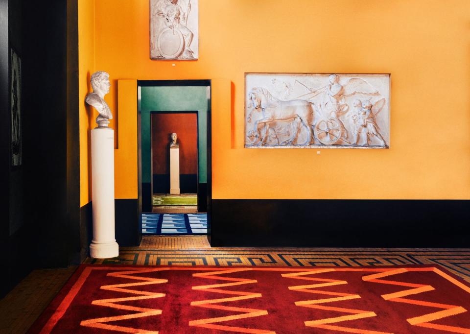 a red rug in a yellow room