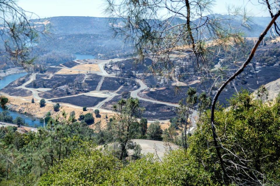 Smoke rises from charred earth near the Oroville Spillway during the Thompson Fire on Wednesday.