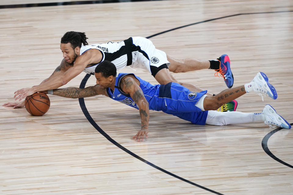 Los Angeles Clippers' Amir Coffey, top, and Dallas Mavericks' Trey Burke dive for the ball during the second half of an NBA basketball first round playoff game Friday, Aug. 21, 2020, in Lake Buena Vista, Fla. The Clippers won 130-122. (AP Photo/Ashley Landis, Pool)