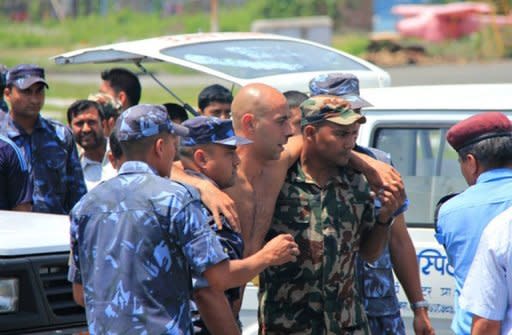 A survivor of a plane crash in northern Nepal is assisted off an aircraft after being evacuated for medical attention to Pokhara Airport. The small plane crashed near a treacherous high-altitude airport, killing 15 people while six others survived