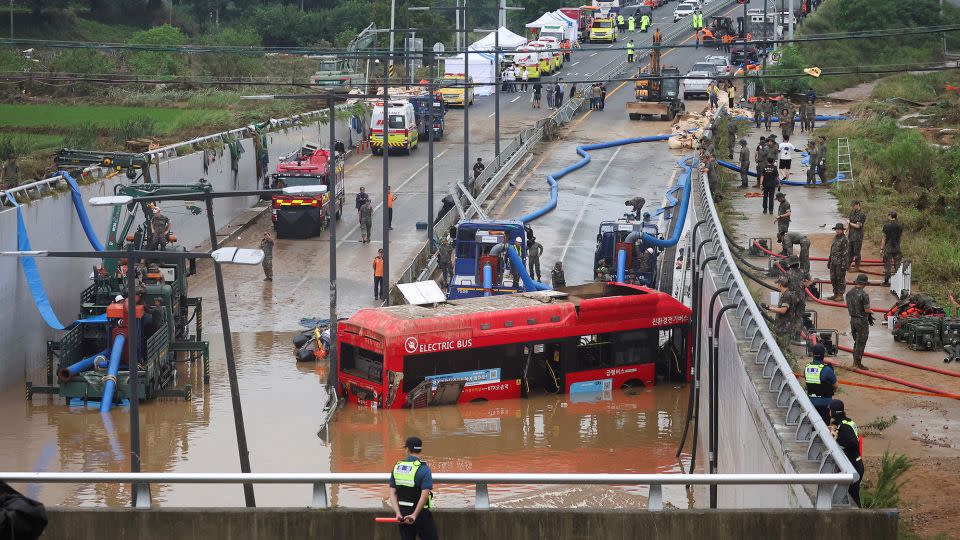 Rescue workers near an underpass submerged by a flooded river in Cheongju, South Korea, on Sunday. - Kim Hong-ji/Reuters