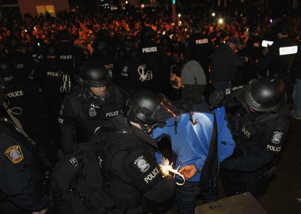 Lexington Police arrest a University of Kentucky student on the streets after University of Connecticut defeated Kentucky in the NCAA Men's National Basketball Championship near the university campus in Lexington, Kentucky, April 7, 2014. REUTERS/ John Sommers II (UNITED STATES - Tags: SPORT BASKETBALL CIVIL UNREST)