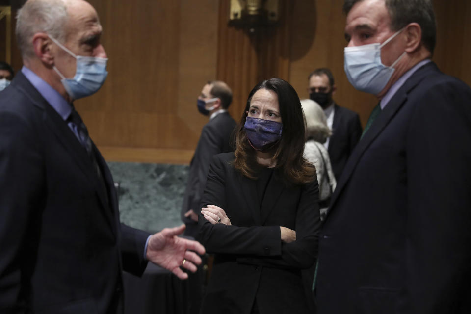 Former Director of National Intelligence Daniel Coats, left, President-elect Joe Biden’s pick for national intelligence director Avril Haines, center, and Sen. Mark Warner, D-Va., talk before a confirmation hearing for Haines before the Senate intelligence committee on Tuesday, Jan. 19, 2021, in Washington. (Joe Raedle/Pool via AP)