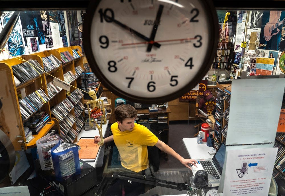 Ontonagon High School student Will Immonen logs the song he's about to play during his shift at WOAS 88.5-FM, the school's student-run radio station, inside the Ontonagon Area Schools building in the western Upper Peninsula on Monday, April 24, 2023.