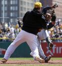 Pittsburgh Pirates' Travis Snider, left, takes down Milwaukee Brewers' Carlos Gomez during a skirmish between the teams during the third inning of a baseball game in Pittsburgh, Sunday, April 20, 2014. Gomez and Snider were ejected from the game. (AP Photo/Gene J. Puskar)