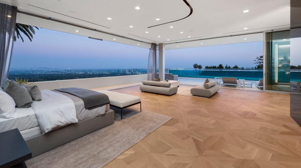 a room with a bed and sweeping views of the city in mansion The One Bel Air