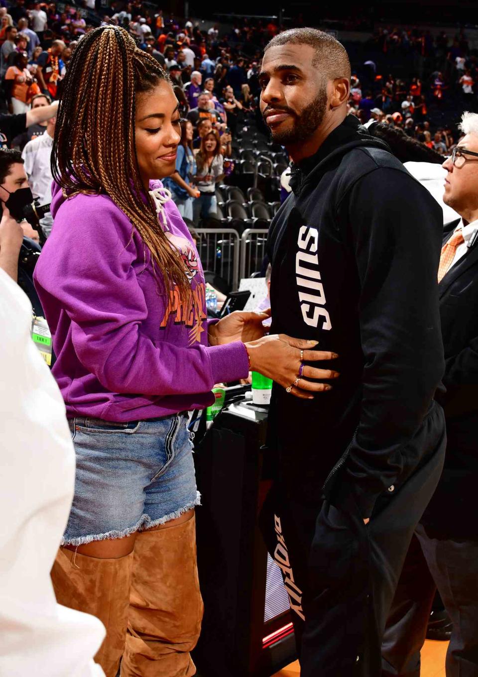 Chris Paul #3 of the Phoenix Suns and his wife Jada Paul embrace after the game during Game 2 of the 2022 NBA Playoffs Western Conference Semifinals on May 4, 2022 at Footprint Center in Phoenix, Arizona