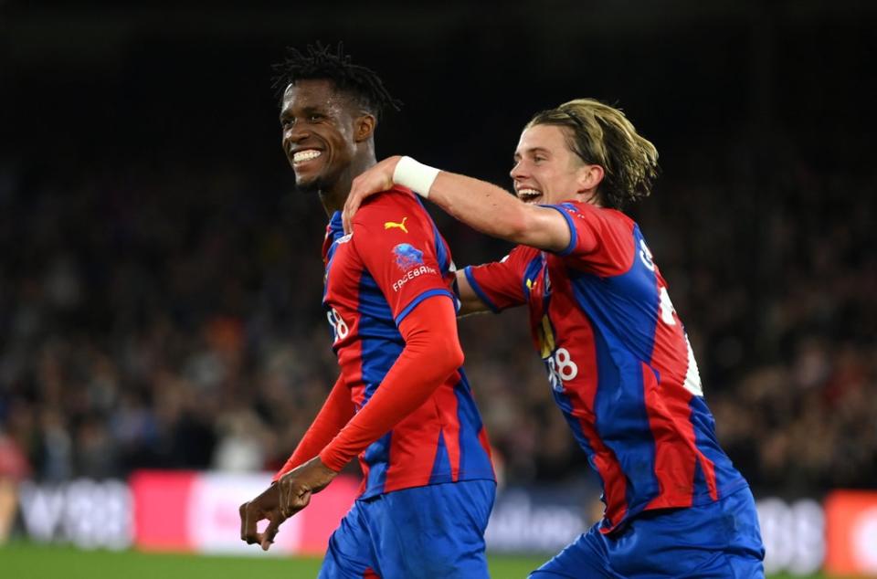 Wilfried Zaha (left) celebrates with Conor Gallagher after giving Crystal Palace the lead (Getty)