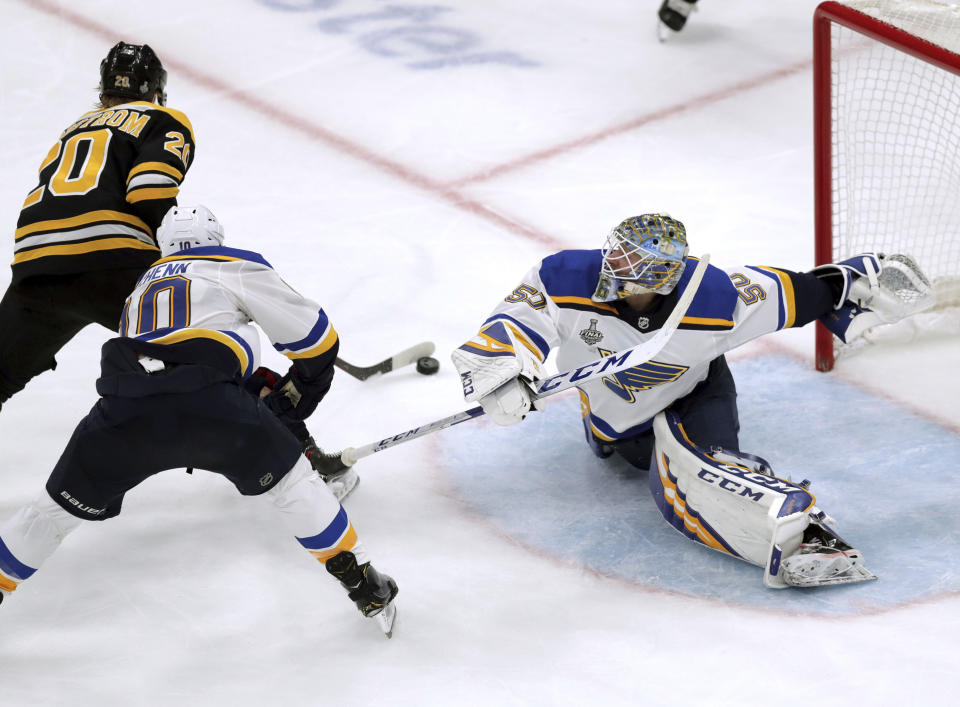 St. Louis Blues goaltender Jordan Binnington, right, stretches to make a save against Boston Bruins' Joakim Nordstrom (20), of Sweden, during the third period in Game 7 of the NHL hockey Stanley Cup Final, Wednesday, June 12, 2019, in Boston. (AP Photo/Charles Krupa)