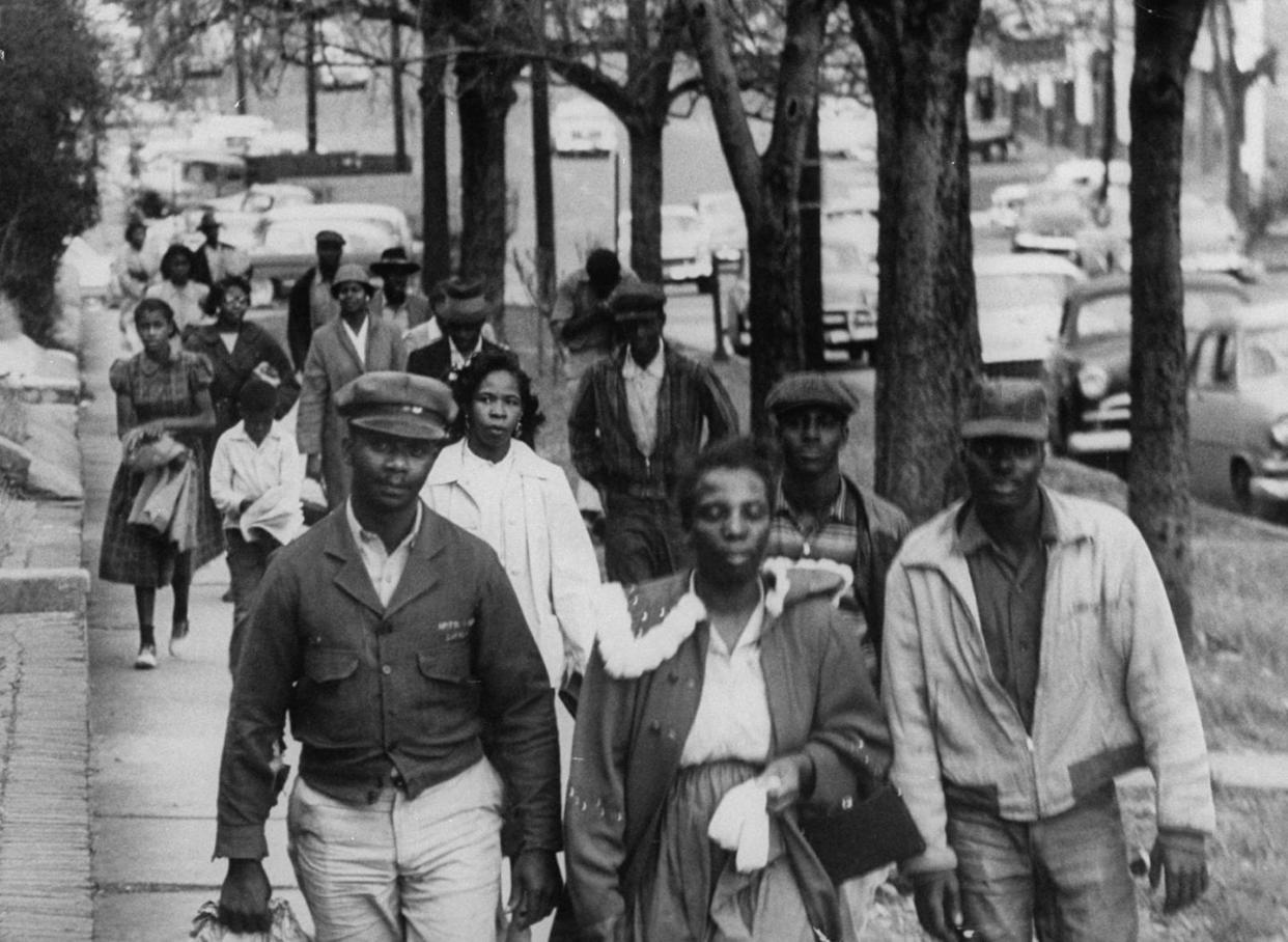 Black demonstrators walk to work during the bus boycott in Montgomery, Ala., in February 1956. <a href="https://www.gettyimages.com/detail/news-photo/african-americans-walk-to-work-instead-of-riding-the-bus-news-photo/50947665?adppopup=true" rel="nofollow noopener" target="_blank" data-ylk="slk:Don Cravens/Getty Images;elm:context_link;itc:0;sec:content-canvas" class="link ">Don Cravens/Getty Images</a>