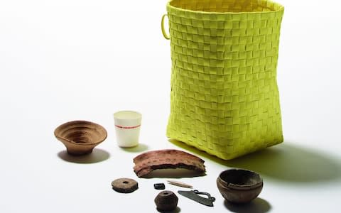 An ancient disposable cup, next to plastic items washed up on a Pacific beach