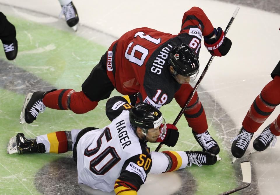 Canada's Kyle Turris, right, challenges Germany's Patrick Hager, left, during the Ice Hockey World Championships group A match between Canada and Germany at the Steel Arena in Kosice, Slovakia, Saturday, May 18, 2019. (AP Photo/Petr David Josek)