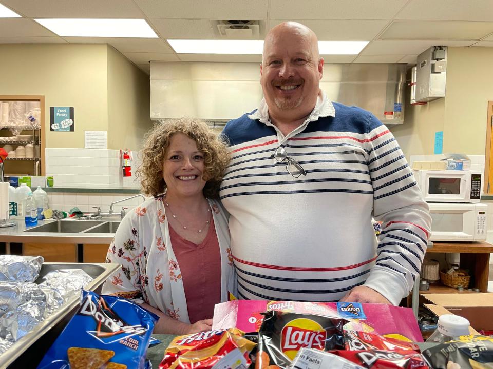 Volunteers Dani Krahn and Rob Krahn serve up hotdogs and chips to the crowd at the Easter Eggstravaganza at West Towne Christian Church, April 2, 2023.