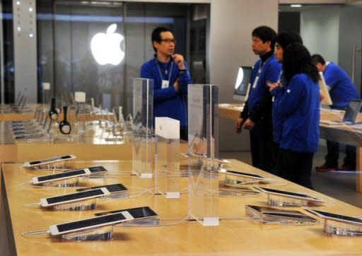 File photo of employees at an Apple store in Tokyo. Apple was seeking 100 million yen ($1.27 million) in compensation from Samsung's Japanese units, and had accused it of stealing technology used to transfer music and video files