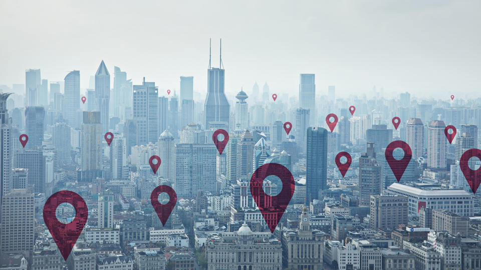 Digital composite image of map pin icons on cityscape of Shanghai
