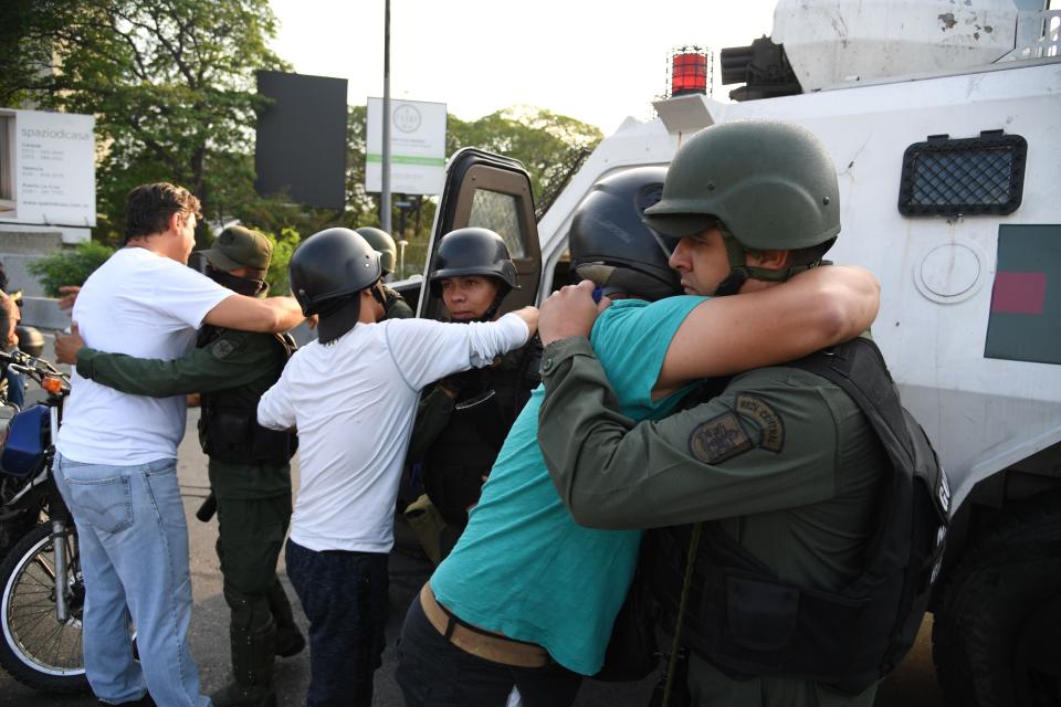 Supoprters of self-proclaimed acting president Juan Guaido hug members of the security forces in Caracas on April 30, 2019. - Venezuelan opposition leader and self-proclaimed acting president  Juan Guaido said on Tuesday that troops had joined his campaign to oust President Nicolas Maduro as the government vowed to put down what it said was an attempted coup. (Photo: Yuri Cortez/AFP/Getty Images)