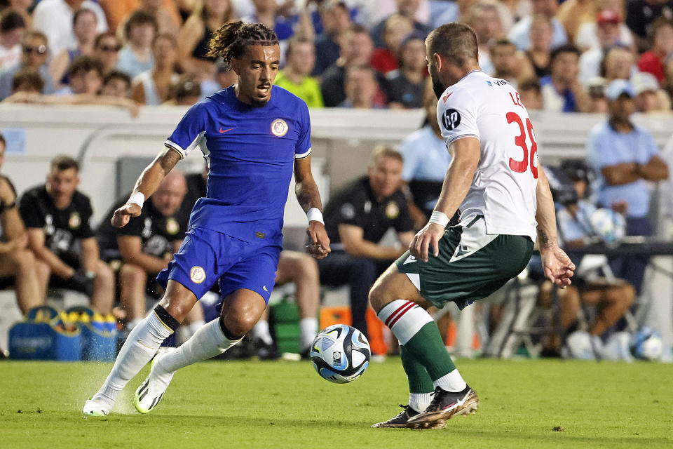 Chelsea's Malo Gusto, left, controls the ball in front of Wrexham's Elliot Lee (38) during the first half of a club friendly soccer match Wednesday, July 19, 2023, in Chapel Hill, N.C. (AP Photo/Karl B DeBlaker)