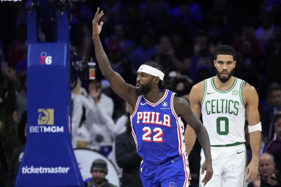 Philadelphia 76ers' Patrick Beverley, left, reacts past Boston Celtics' Jayson Tatum after making a basket during the second half of an NBA basketball game, Wednesday, Nov. 8, 2023, in Philadelphia. (AP Photo/Matt Slocum)