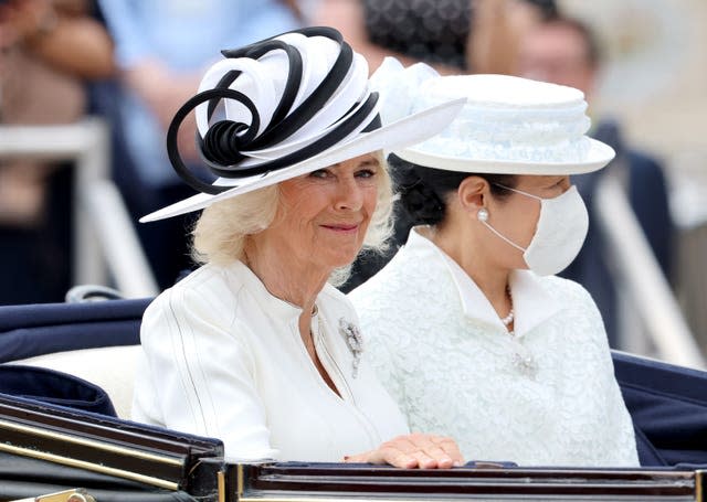 The Queen travelling in a carriage with Empress Masako of Japan, who was wearing a face mask