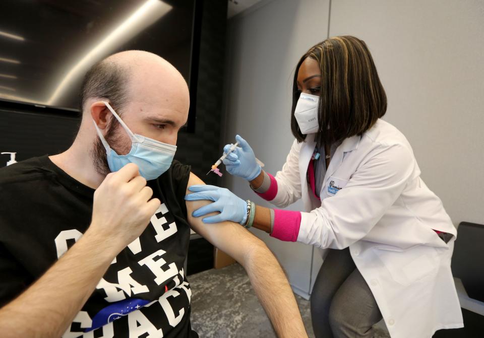 Starlena Moore administers a COVID-19 vaccine to Jimmy Else, 35, at the offices of YAI in New York City, Dec. 28. 2020. YAI is an agency that provides services to individuals with intellectual and/or developmental disabilities.