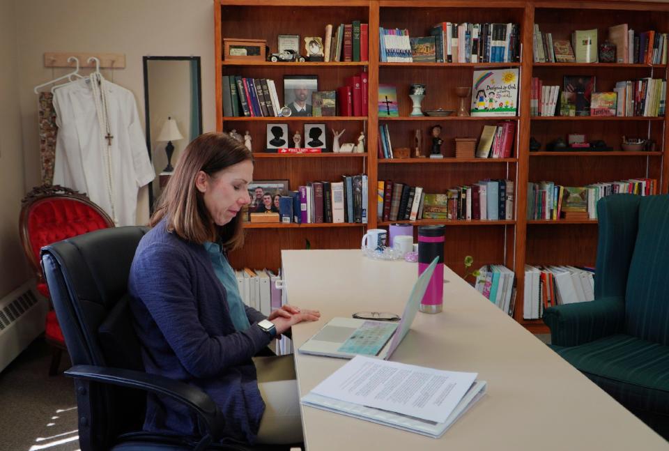 The Rev. Jillene Gallatin, of Grace Lutheran Church, prays with her fellow clergy members at the start of their online suicide prevention course, in Waseca, Minn., on Thursday, May 4, 2023. For Gallatin, the call to prevention is excruciatingly personal. At age 15, she tried to kill herself a year after her mother took her own life. And it was in her church that she found comfort and a listening ear. (AP Photo/Jessie Wardarski)