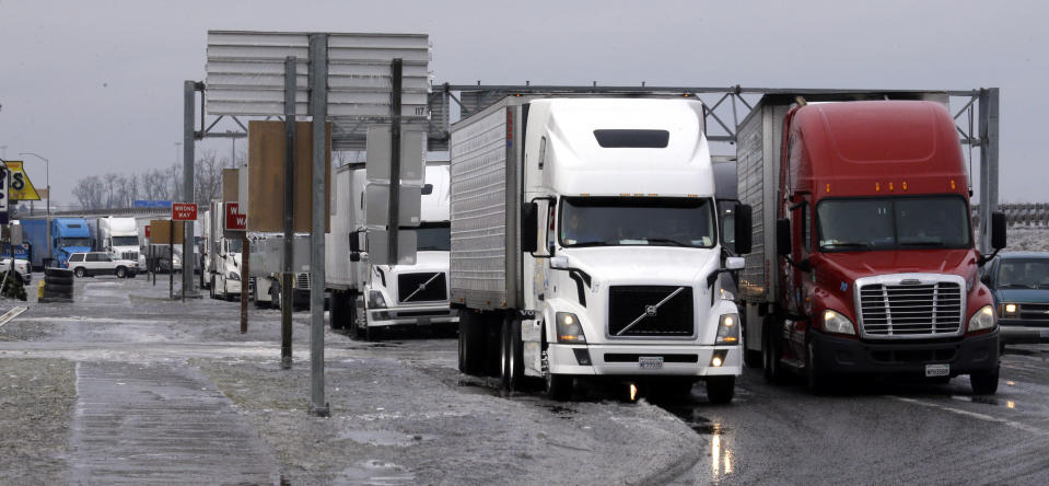 Semi trucks are double parked on the eastbound Interstate 84 off ramp after the freeway was closed in Troutdale, Ore., Wednesday, Jan. 18, 2017. An ice storm shut down parts of major highways and interstates Wednesday in Oregon and Washington state and paralyzed the hardest hit towns along the Columbia River Gorge with up to 2 inches of ice coating the ground in some places. (AP Photo/Don Ryan)