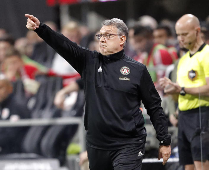 FILE - In this Nov. 25, 2018, file photo, Atlanta United head coach Gerardo Tata Martino directs his players in a MLS soccer playoff game against the New York Red Bulls, in Atlanta. Martino will be celebrated for bringing instant MLS success to Atlanta. If he can add the MLS Cup championship to Atlanta United in his final game as coach, his status as a legend will be difficult for his successor to match. (AP Photo/John Bazemore, File)