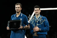 Serbia's Novak Djokovic, right, and Russia's Daniil Medvedev hold their trophies after their final match of the Paris Masters tennis tournament at the Accor Arena in Paris, Sunday, Nov.7, 2021. Djokovic won 4-6, 6-3, 6-3. (AP Photo/Thibault Camus)