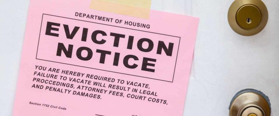 Pink Eviction Notice Taped on Front Door.