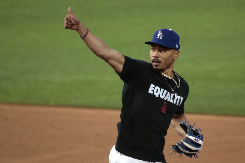 Arlington, Texas, Sunday, October 11, 2020. Mookie Betts flashes the thumbs up sign to coaches after working out.