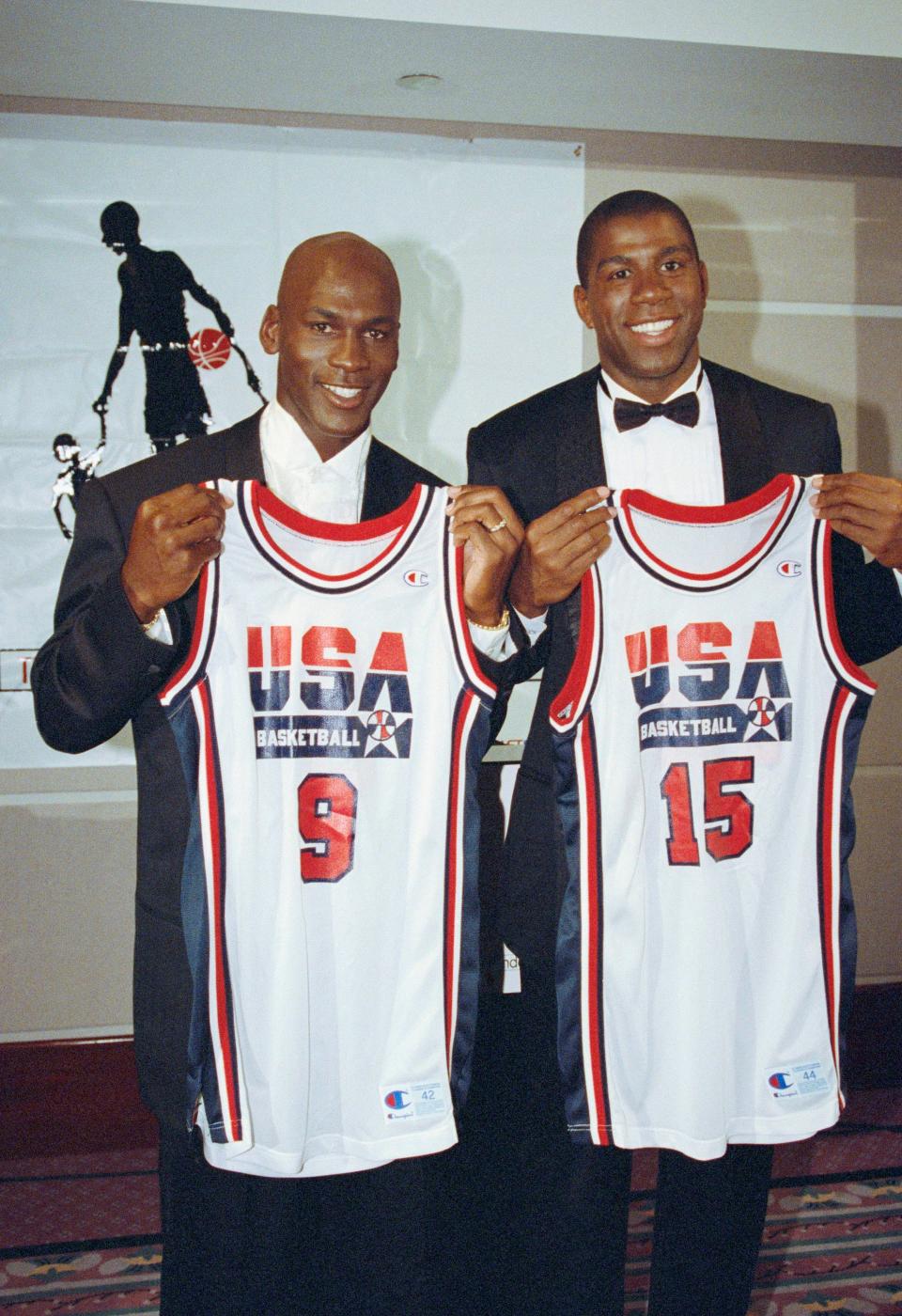 Michael Jordan, left, and Magic Johnson hold up their uniforms for the 1992 US Olympic basketball team.