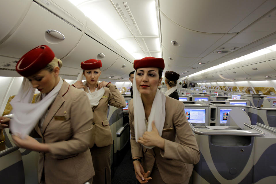 In this Sunday, Feb. 10, 2013, photo emirates cabin attendants prepare the inside an Airbus A380 aircraft for a flight at the new Concourse A of Dubai airport in Dubai, United Arab Emirates. For generations, international fliers have stopped over in London, Paris and Amsterdam. Now, they increasingly switch planes in Dubai, Doha and Abu Dhabi, making this region the new crossroads of global travel. The switch is driven by both the airports and airlines, all backed by governments that see aviation as the way to make their countries bigger players in the global economy. (AP Photo/Kamran Jebreili))