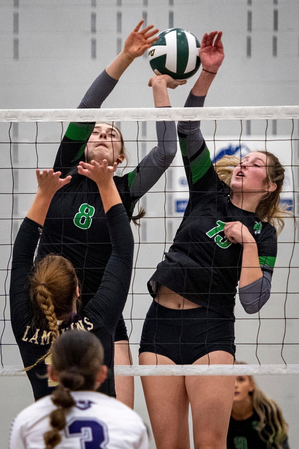 Fossil Ridge volleyball players Delaney Ewing, left, and Maya Siple defend the net against a hit by Fort Collins' Claire Wagstaff during their match at Fossil Ridge High School on Thursday.