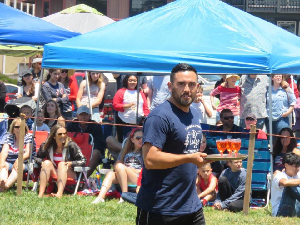 A participant in the waiter/waitress race in the Fourth of July celebration at Cambria’s Shamel Park on Thursday, July 4, 2019.