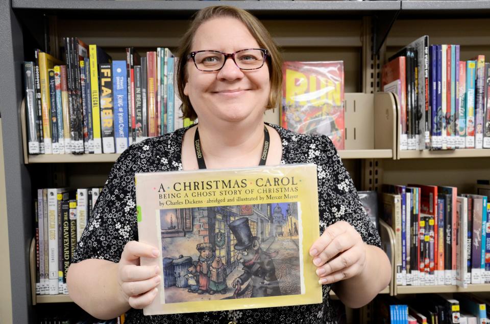 Nisa Kesseler, tween/teen services librarian at the Petoskey District Library, holds a kid-friendly version of "A Christmas Carol," her favorite holiday book.