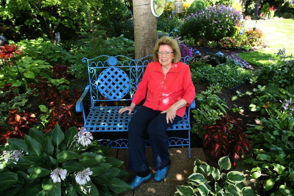 Dorothy Danforth takes a breather from gardening on Aug. 10 at her Brown Deer home. She often gives people tours of the gardens.