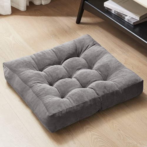 square gray mediation cushion on wood floor