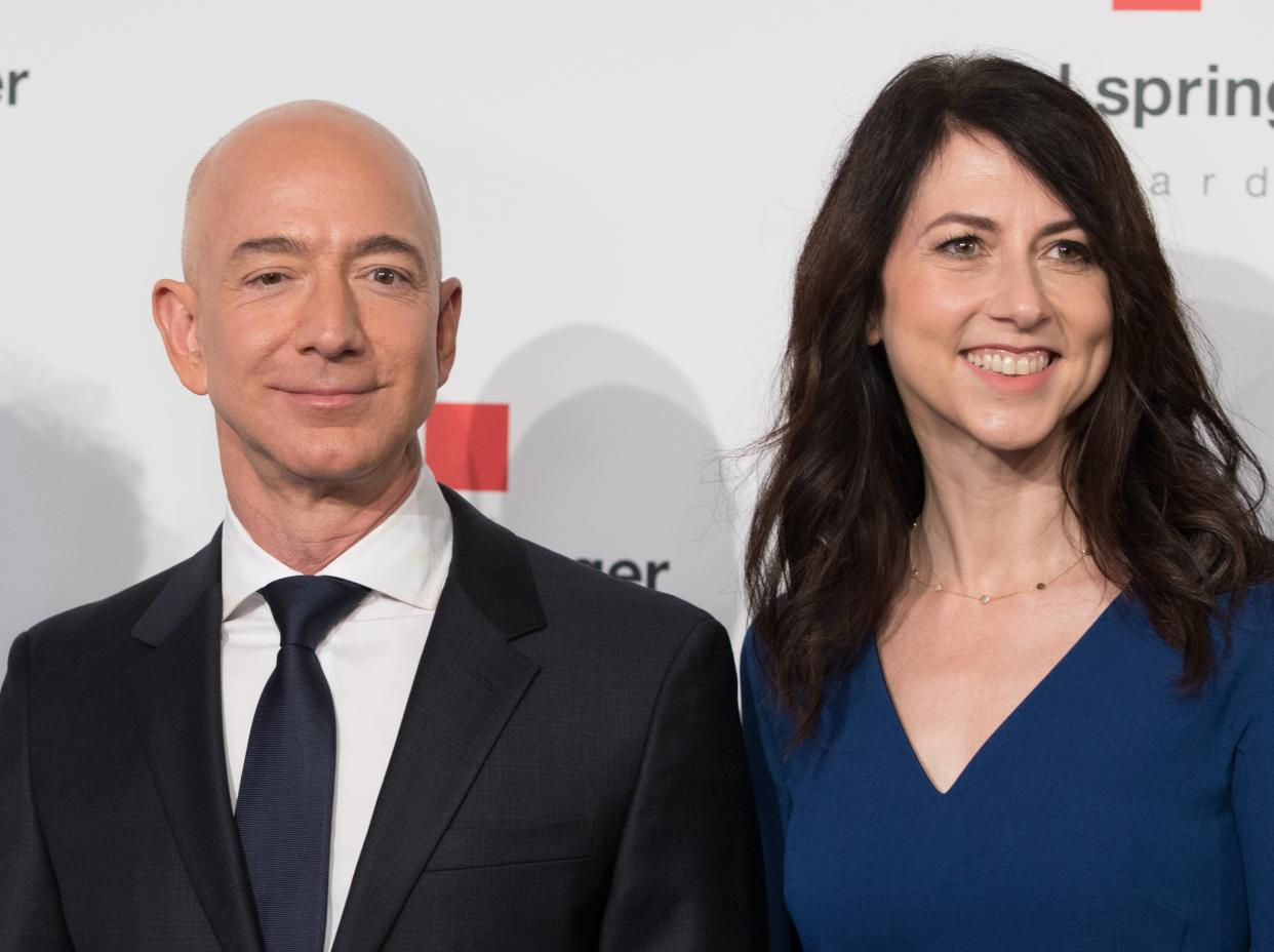 <p>Amazon CEO Jeff Bezos and his wife MacKenzie Bezos poses as they arrive at the headquarters of publisher Axel-Springer where he will receive the Axel Springer Award 2018 on April 24, 2018 in Berlin.</p> (Photo by JORG CARSTENSEN/dpa/AFP via Getty Images))