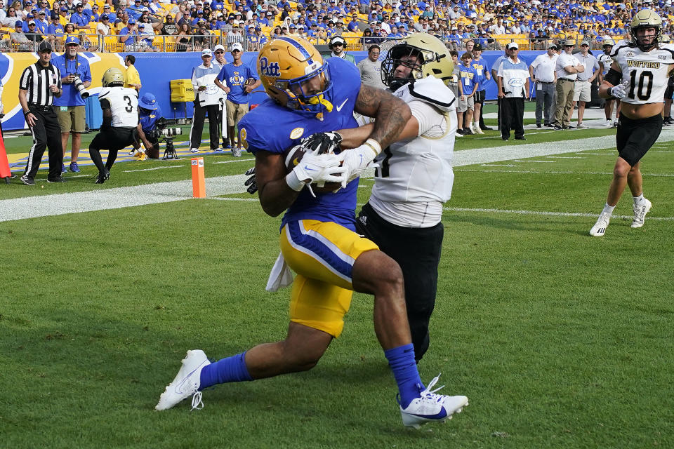 Pittsburgh tight end Karter Johnson, left, catches a pass from quarterback Phil Jurkovec for a touchdown with Wofford defensive back Chase Soper defending during the second half of an NCAA college football game in Pittsburgh, Saturday, Sept. 2, 2023. (AP Photo/Gene J. Puskar)