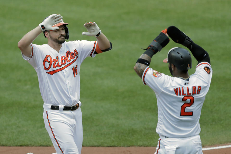 Baltimore Orioles' Trey Mancini, left, is greeted at home plate by Jonathan Villar after hitting a two-run home run off Boston Red Sox starting pitcher Andrew Cashner that scored them during the third inning of a baseball game, Sunday, July 21, 2019, in Baltimore. (AP Photo/Julio Cortez)