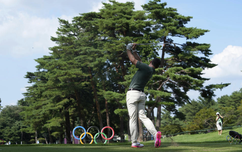 Rory McIlroy of Ireland watches his tee shot on the 16th hole during the third round of the men's golf event at the 2020 Summer Olympics on Saturday, July 31, 2021, in Kawagoe, Japan. (AP Photo/Andy Wong)