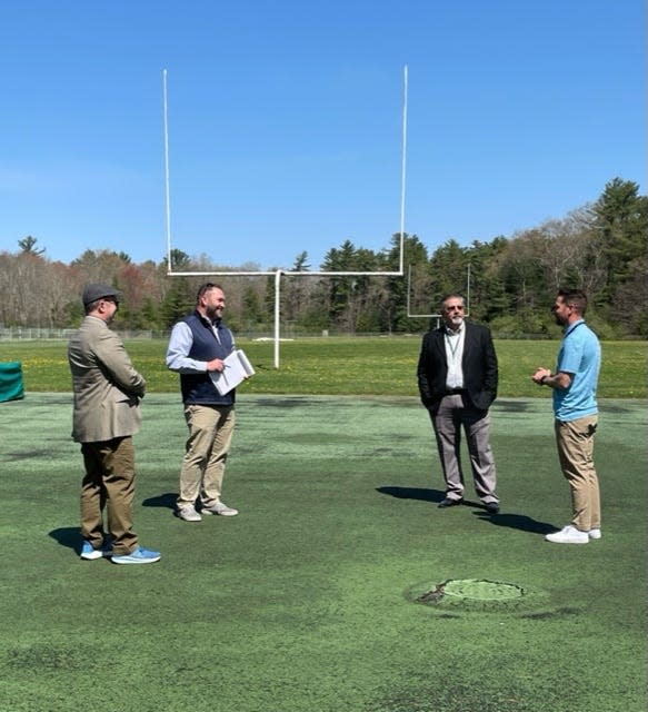 From left Business Administrator Robert Baxter, Kristoff Eldridge of Cape and Island Tennis & Track, Superintendent Anthony Azar and teacher/track coach Brendan De Lano discuss plans for a new track at Dighton-Rehoboth Regional High School.